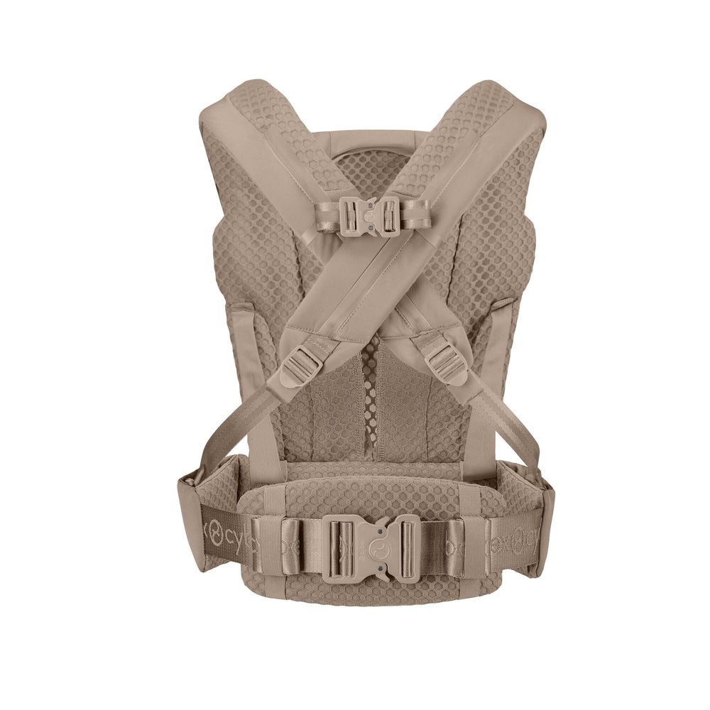 Close-up of the Cybex Coya Carrier beige cybex coya baby carrier with padded honeycomb-mesh back, cross-shoulder straps, and waist buckle.
