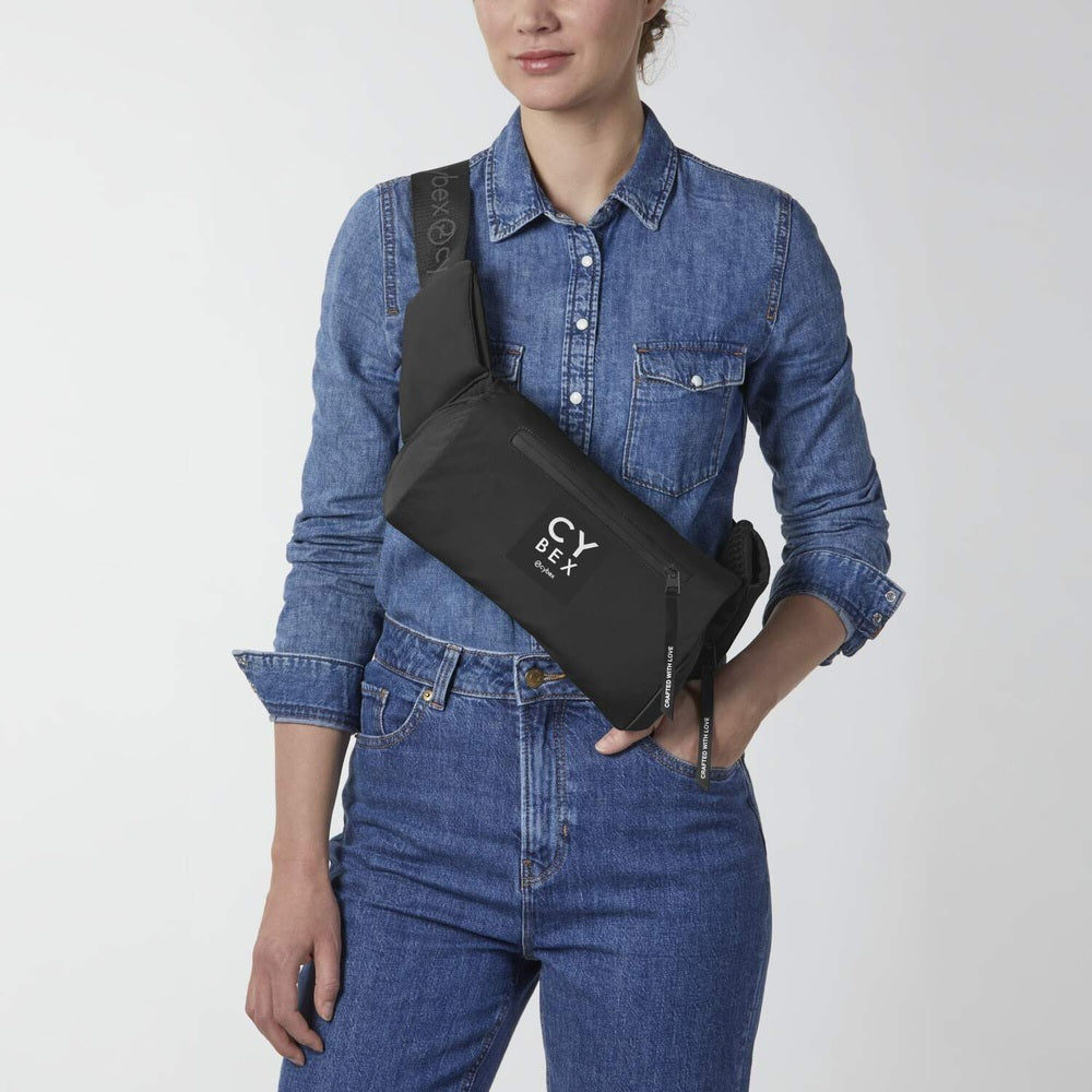Close-up of the Cybex Coya Carrier black crossbody with logo strap for hands-free baby transport.