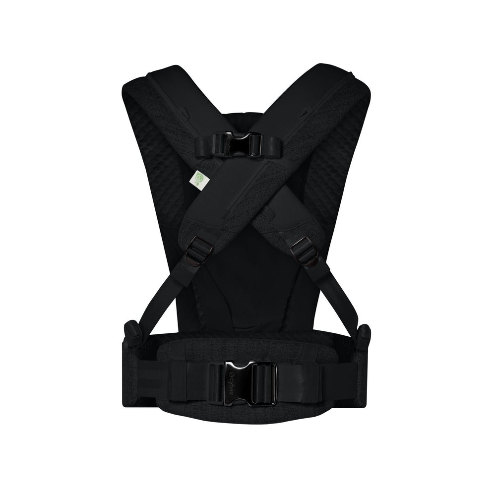 Close-up of the Cybex Coya Carrier Boucle black boucle fabric cybex coya baby carrier with padded shoulder straps and waist belt.