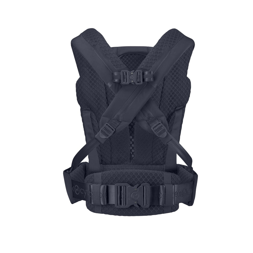 Close-up of the Cybex Coya Carrier in dark navy with padded shoulder straps, mesh back panel, and wide adjustable waist belt.