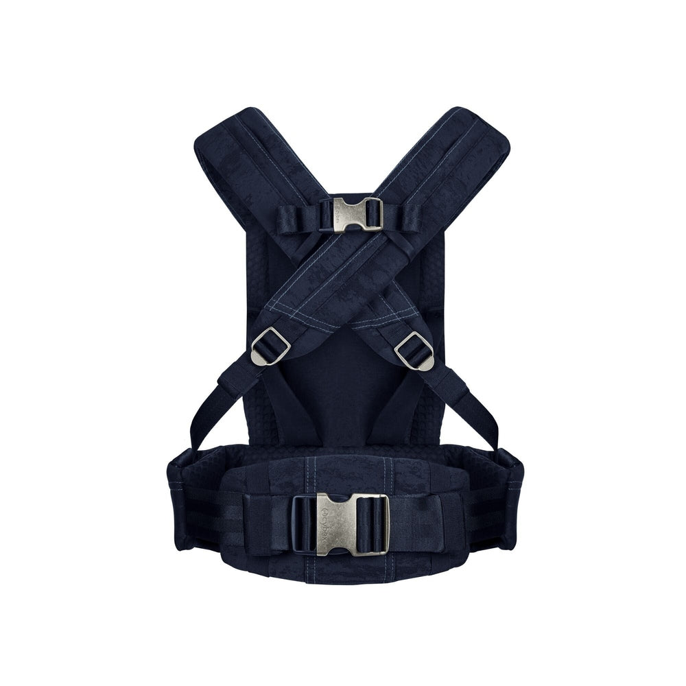 Close-up of the Cybex Coya Carrier Rebellious Luxury Denim Blue denim blue cybex coya baby carrier back view with cross-back padded straps and silver buckles.