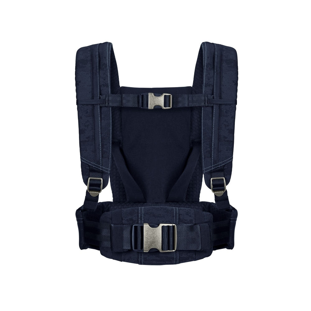 Close-up of the Cybex Coya Carrier Rebellious Luxury Denim Blue in rebellious denim blue with padded shoulder straps, waist belt and metal buckles.