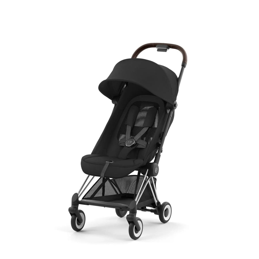 Close-up of the Cybex Coya Chrome Frame Stroller in black with brown leatherette handlebar and compact canopy.