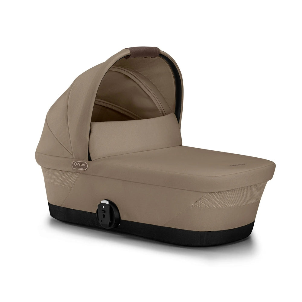 Close-up of the Cybex Gazelle S V2 Cot in beige with integrated bassinet attached to a stroller frame and carry handle.