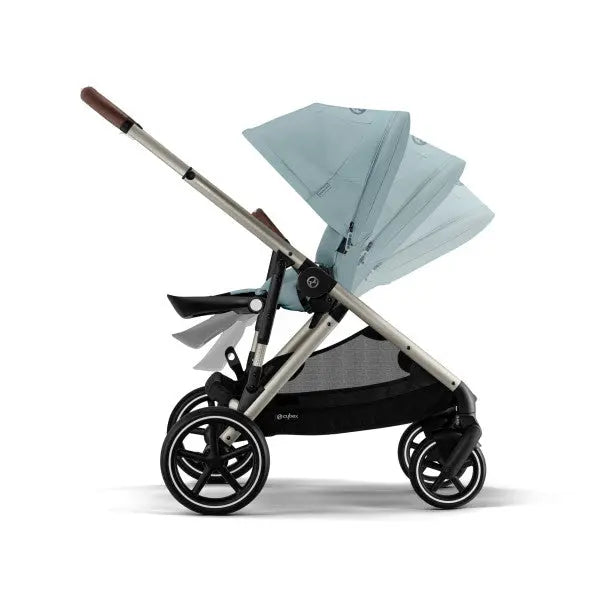 Close-up of the Cybex Gazelle S V2 Stroller teal canopy and silver frame, showing adjustable handle and large wheels in ready-to-use pose.