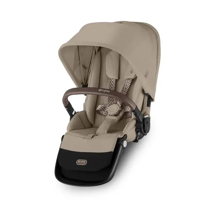 Close-up of the Cybex Gazelle S V2 Toddle Seat in beige with canopy up, brown leather-style handlebar, and secure seat harness.