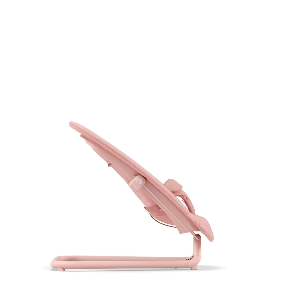 Close-up of the Cybex Lemo 2 Bouncer in pink fabric, compact baby seat shown mid-fold on a pastel pink frame.