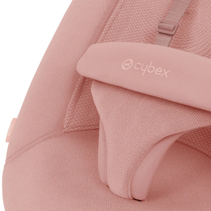 Close-up of the Cybex Lemo 2 Bouncer in soft pink fabric with padded headrest and safety strap, close-up view.