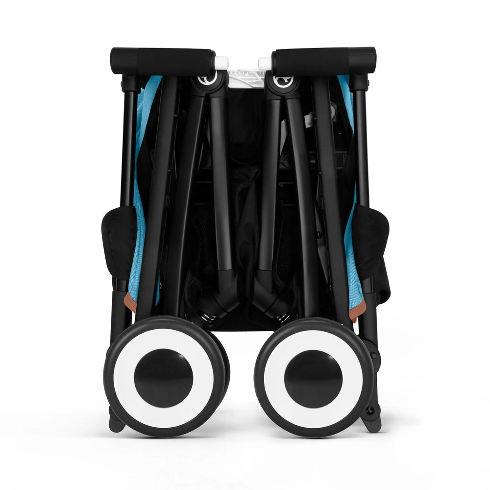 Close-up of the Cybex Libelle Stroller folded for compact storage, showing black frame, blue accents, and large white-rimmed wheels.