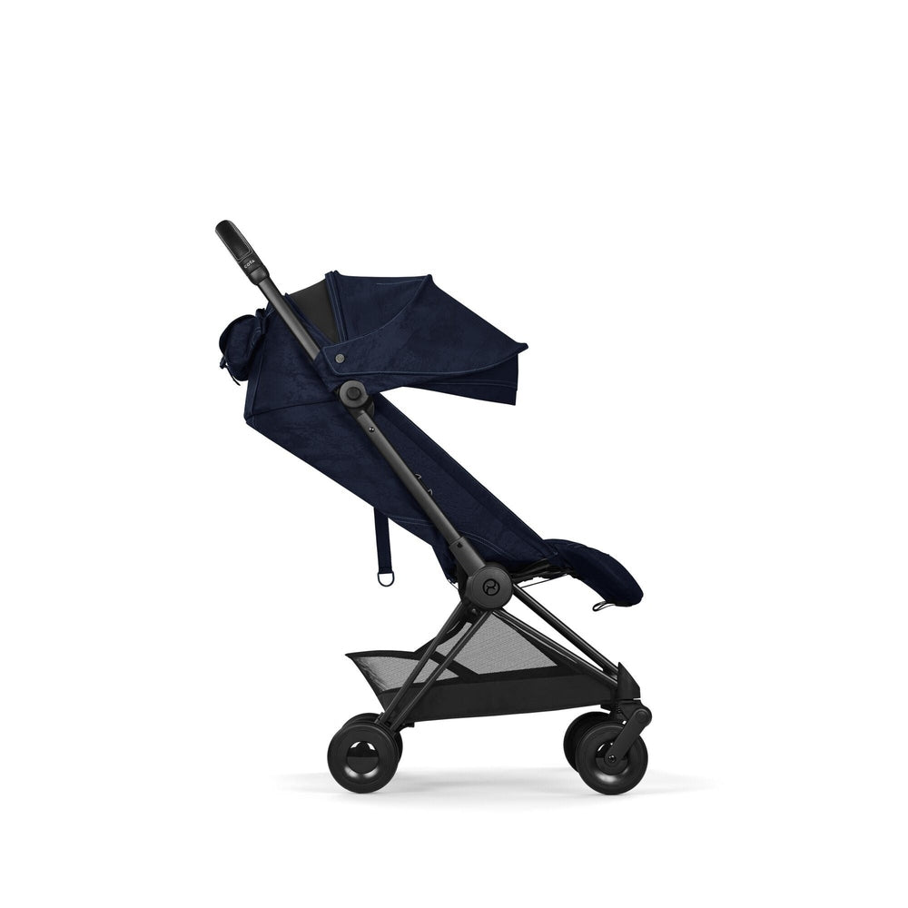 Close-up of the Cybex Platinum Coya Compact Lightweight Stroller - Rebellious Luxury Denim Blue denim-blue fabric on cybex coya compact lightweight stroller with black frame and extended canopy.