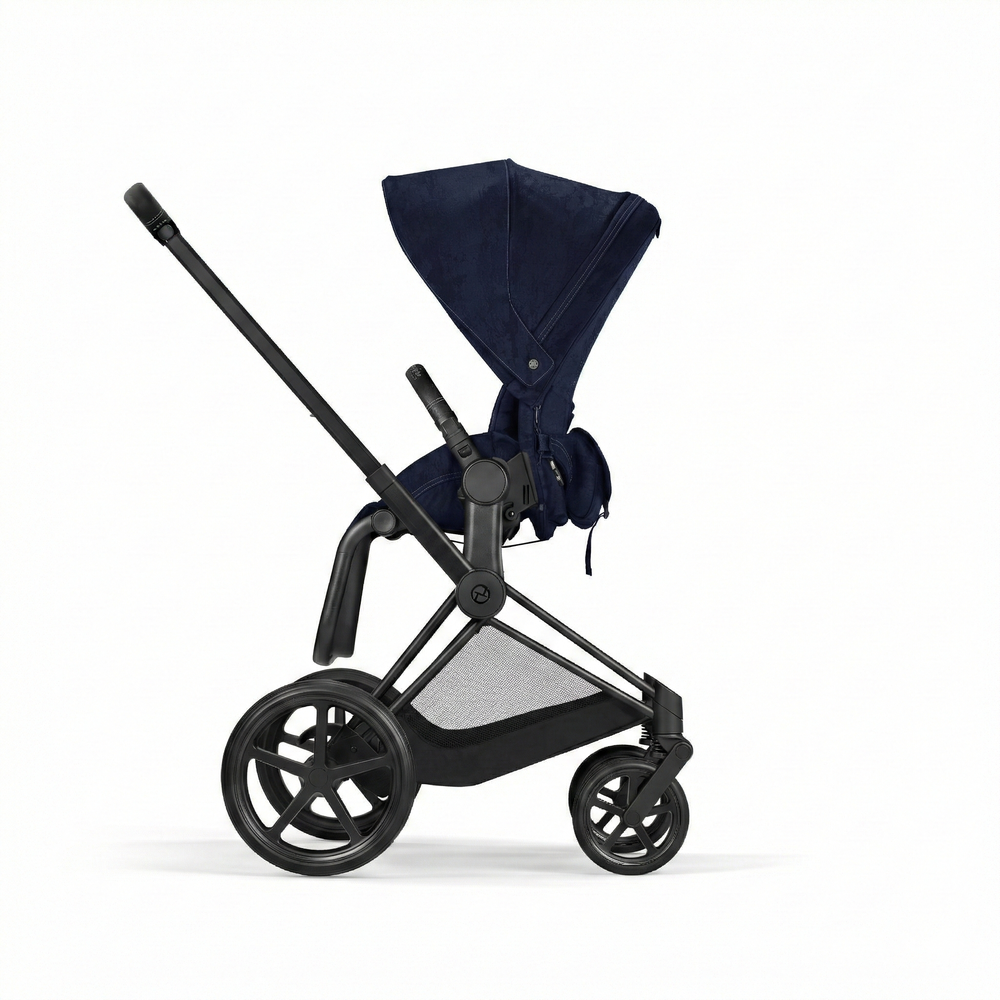 Close-up of the Cybex Platinum Priam 4 Stroller Limited Edition - Rebellious Luxury Denim Blue denim blue cybex priam 4 stroller with black frame, extendable navy canopy, and mesh storage basket.