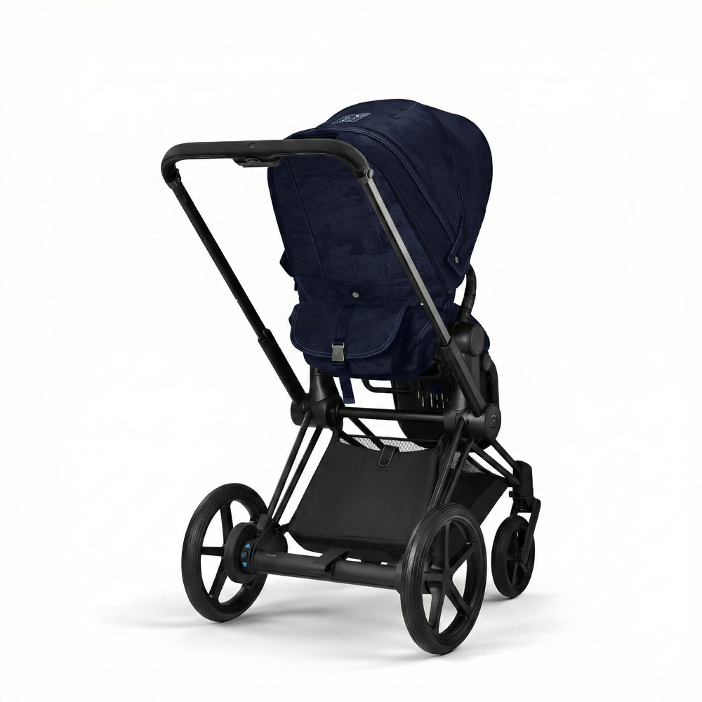 Close-up of the Cybex Platinum Priam 4 Stroller Limited Edition - Rebellious Luxury Denim Blue denim-blue cybex priam 4 stroller in denim fabric with black frame and large rear wheels.