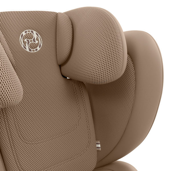 Close-up of the Cybex Solution G2 Booster Seat in tan mesh fabric with contoured headrest and armrests.