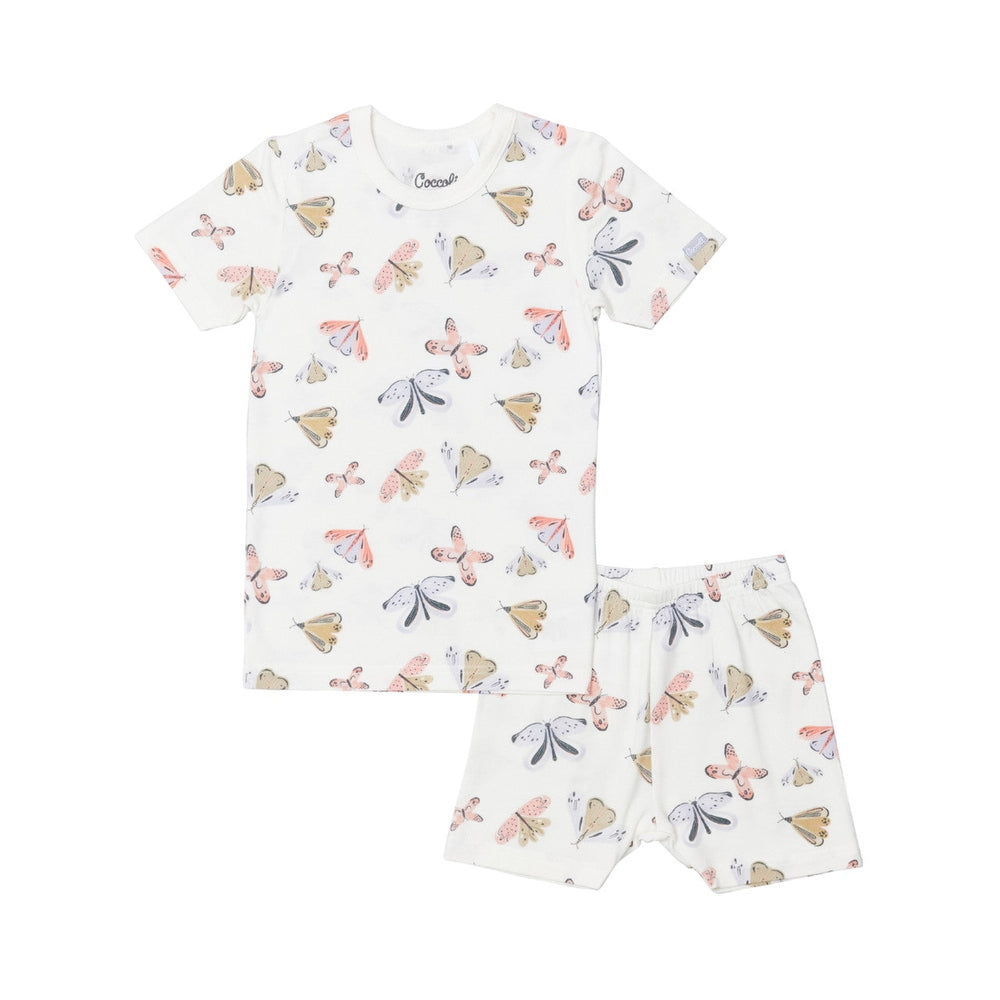 Coccoli Kid short-sleeve pyjama set in cream with pastel butterfly print, laid flat to show allover butterflies in cotton TENCELTM Modal.