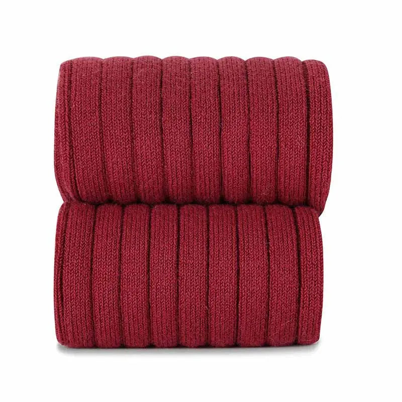 Condor Basic Rib Tights Tronco for babies, burgundy ribbed knit fabric shown folded in two tidy stacks.