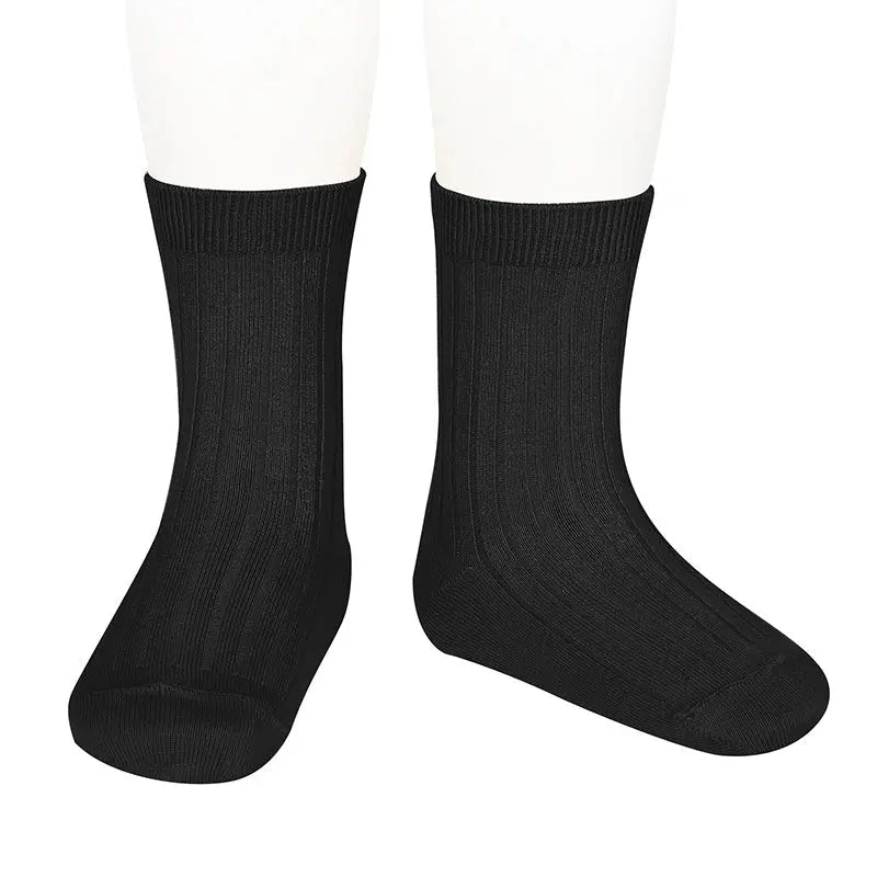 Condor Basic Short Socks Black, pair of black baby socks worn on feet for cozy warmth.