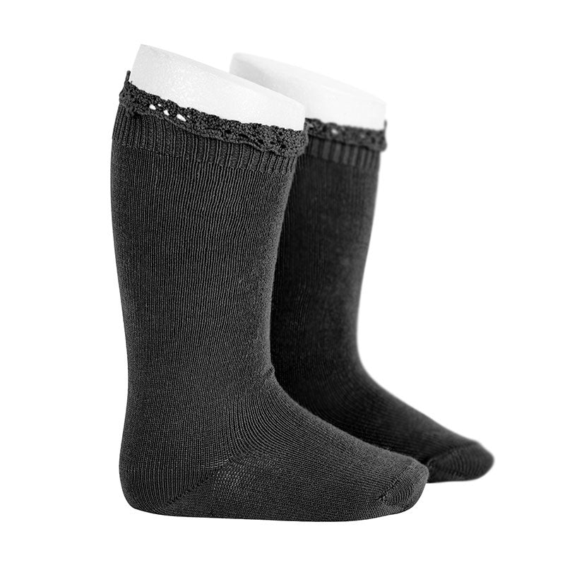 Condor Knee Socks With Lace Edging Cuff Black, two-pack, pulled up on white display legs.