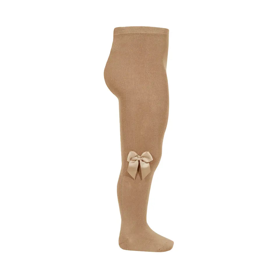 Condor Tights With Side Grosgrain Bow Camel worn on a baby's leg showcasing a side bow.