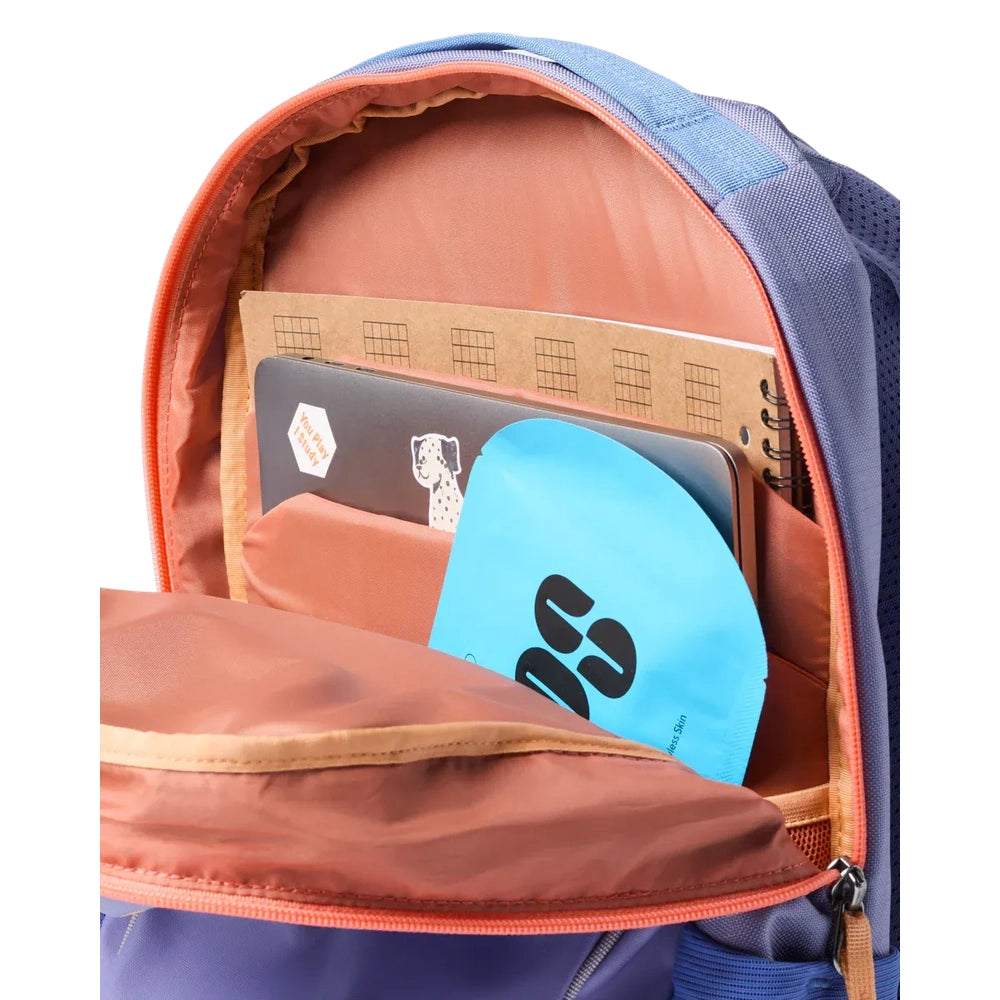 Cotopaxi Allpa 18L Daypack in blue with orange interior; main compartment open showing notebook and blue circular item.