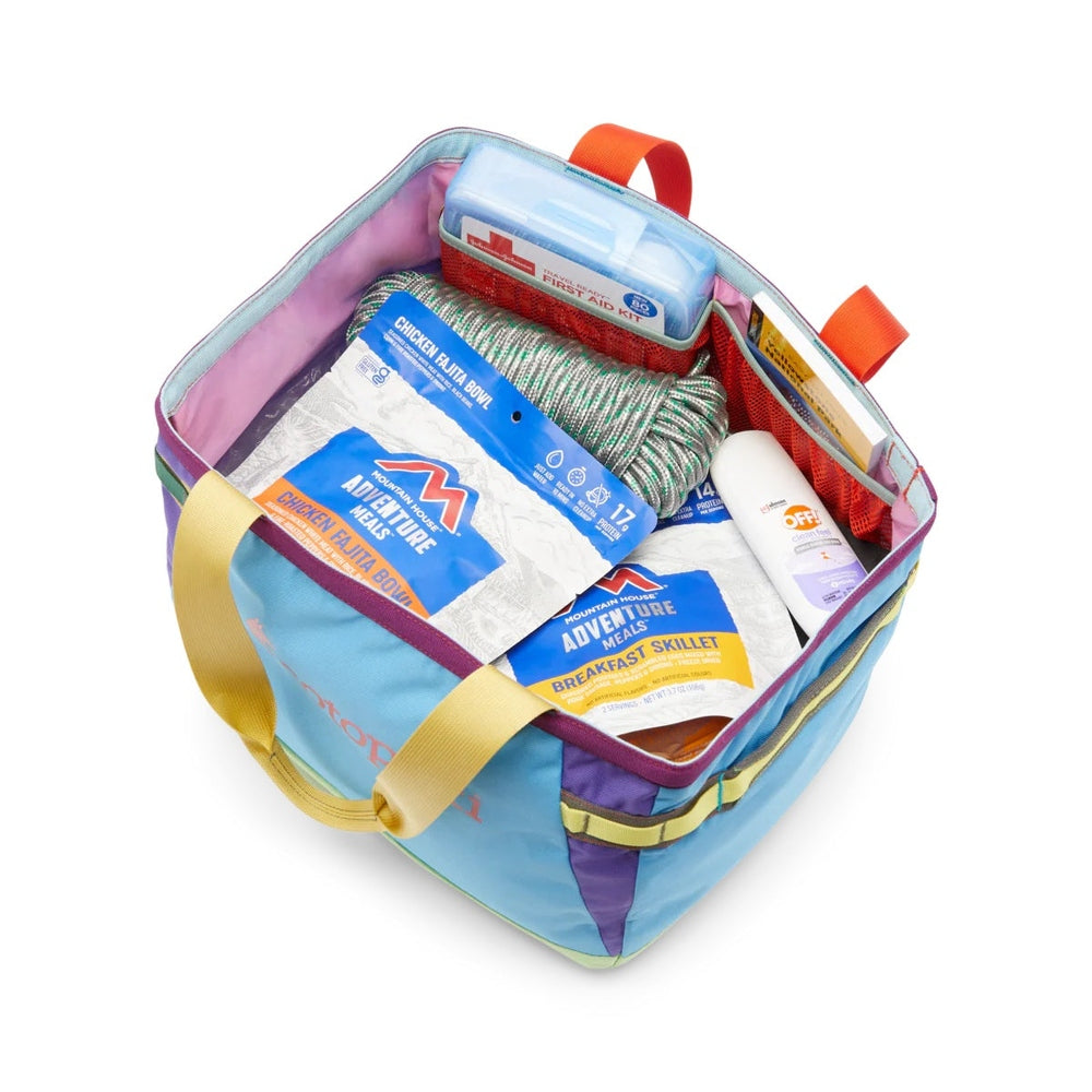 Cotopaxi Allpa 30L Gear Hauler Tote in turquoise and purple with pink interior and orange handles