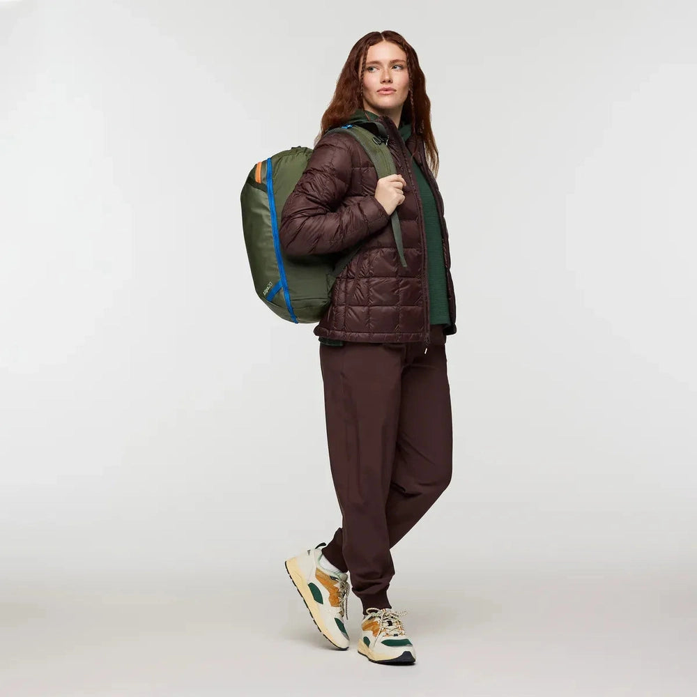 Cotopaxi Allpa Mini 20L Travel Pack in olive green with blue zipper trim.