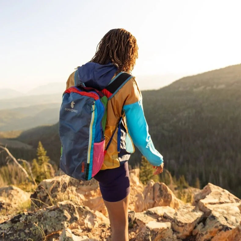 Cotopaxi Batac 16L Del Dia, daypack worn on a mountain trail; example colourway