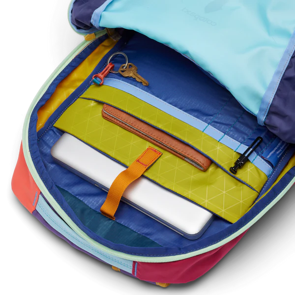 Cotopaxi Chiquillo 26L Daypack in multicolor interior with lime-green organizer and orange strap securing laptop.