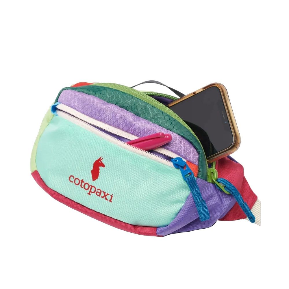 Cotopaxi Kapai 1.5L Hip Pack in multicolor teal purple green red with phone in outer pocket.