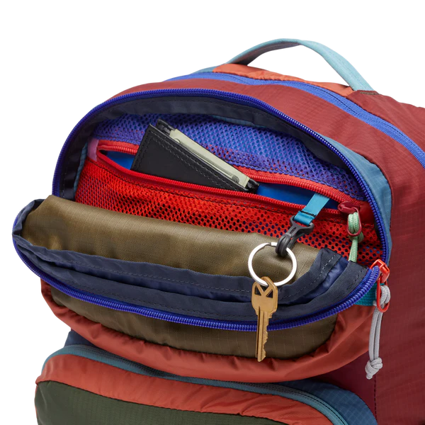 Cotopaxi Tasra 16L Backpack in Orange-Red shell with blue zippers and teal handle