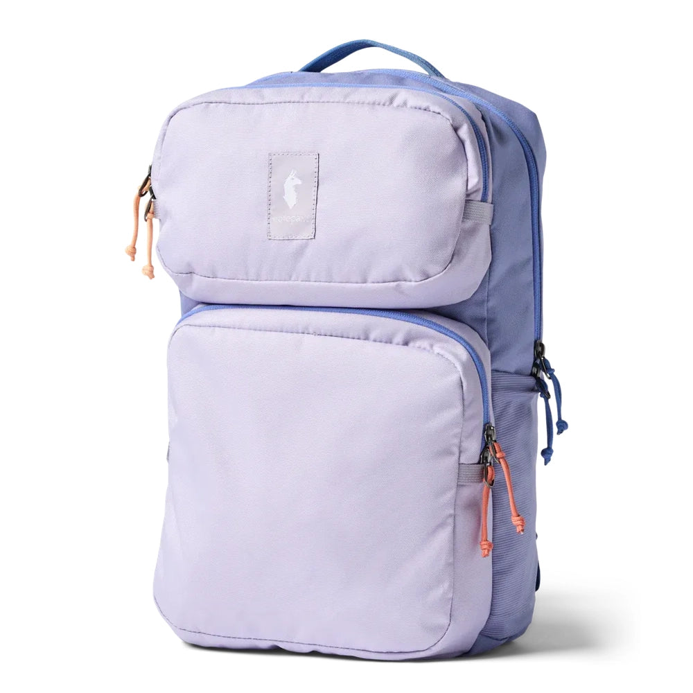 Cotopaxi Tasra 16L Daypack in Lavender with two front pockets and orange zipper pulls.