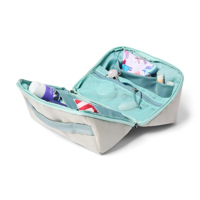 Cotopaxi Travel Toiletry Kit in light gray exterior with teal interior, open view showing mesh pocket.