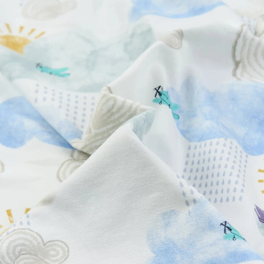 NEST DESIGNS Nest Designs Bamboo Crib Sheet Small Fluffy Puffs weather pattern with sun, clouds, and airplanes; elastic corners img 6/6