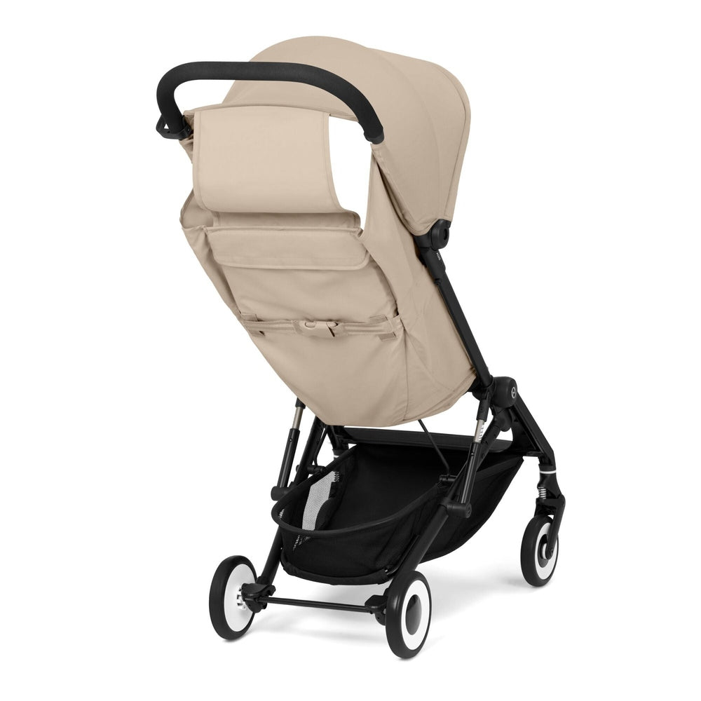 Close-up of the Cybex Agis Lightweight Travel Stroller beige cybex agis travel stroller with black frame, beige fabric seat, curved handle, and under-seat storage basket.