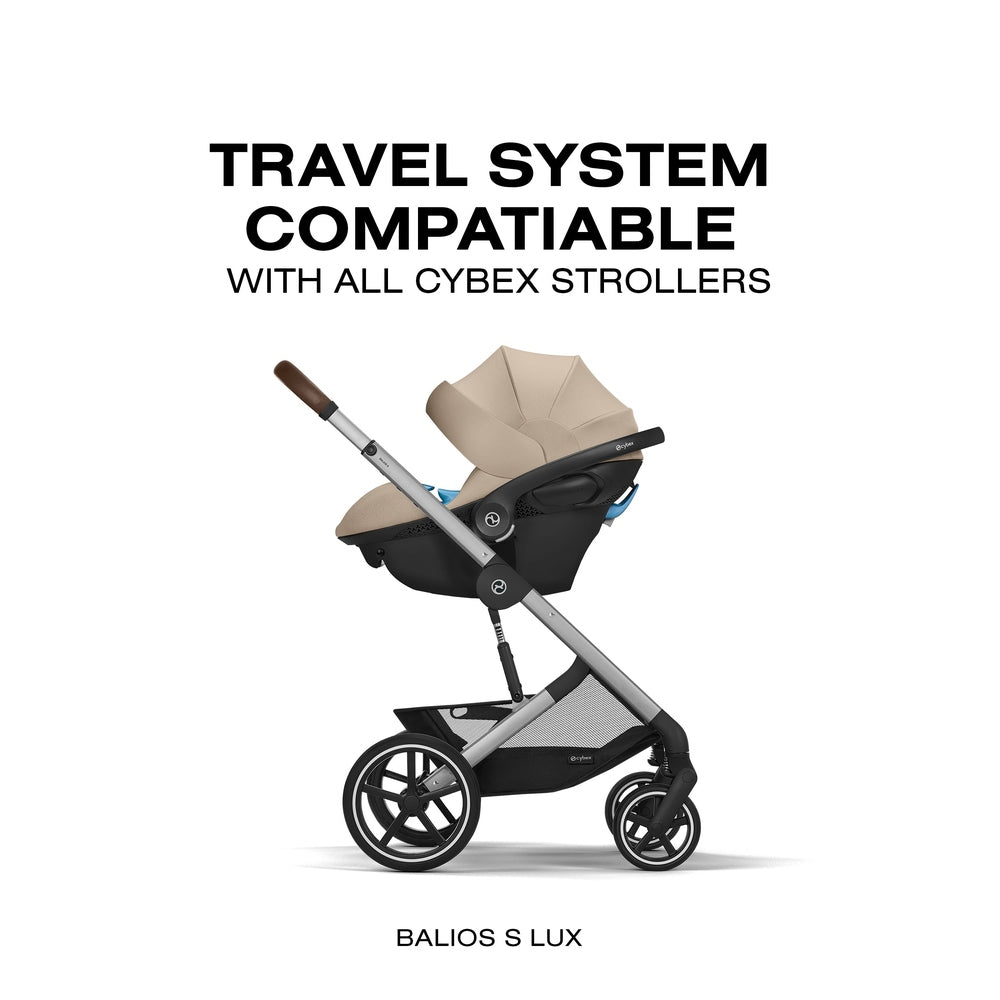 Close-up of the Cybex Aton G Swivel Sensorsafe Infant Car Seat beige cybex aton g infant car seat on gray travel-system frame with brown handle grip.