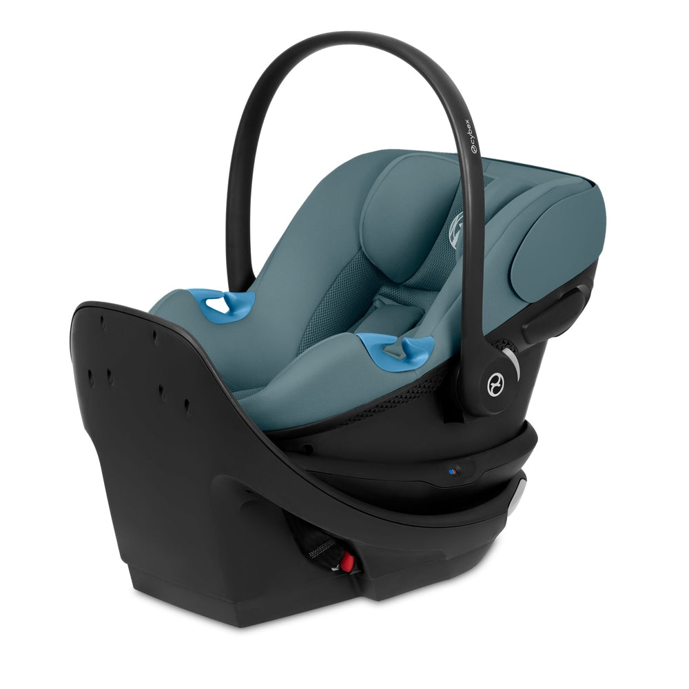 Close-up of the Cybex Aton G Swivel Sensorsafe Infant Car Seat teal fabric interior cybex aton g swivel sensorsafe infant car seat with black shell and curved carry handle.