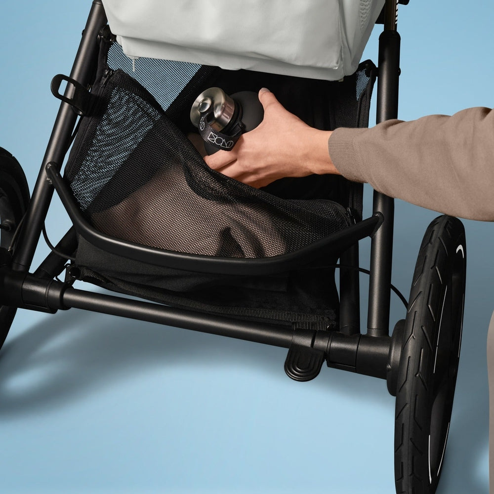 Lifestyle image of the Cybex Avi Spin All Terrain Stroller shown in black,.