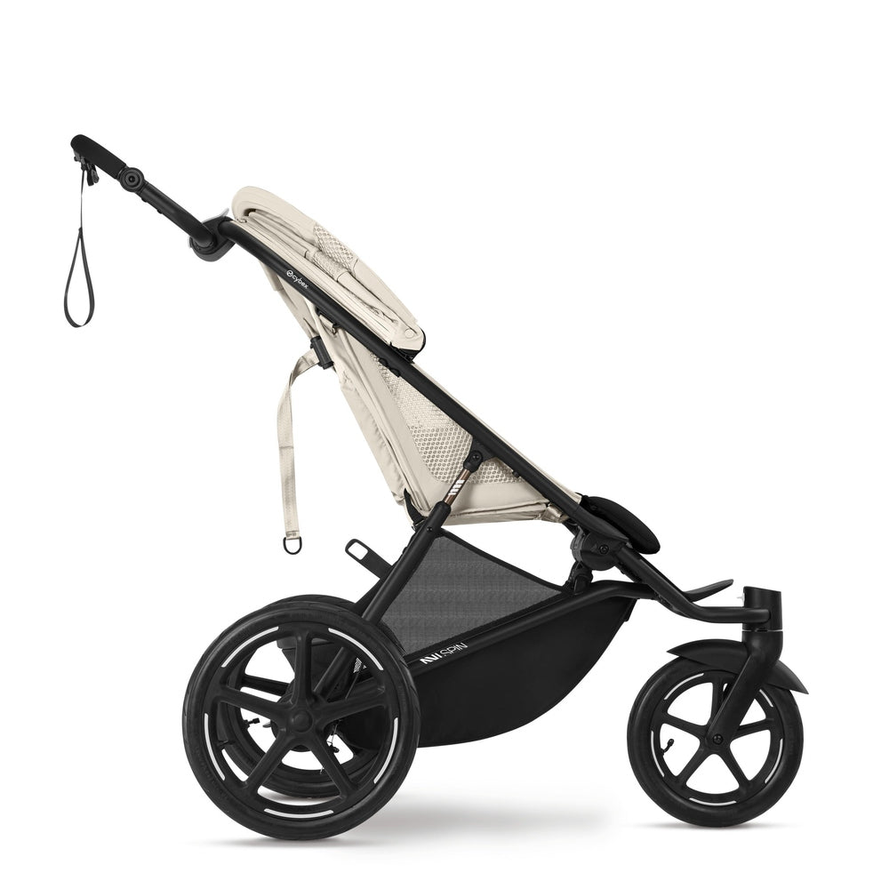 Close-up of the Cybex Avi Spin All Terrain Stroller in beige with black frame; large rear wheels demonstrate its off-road capability.