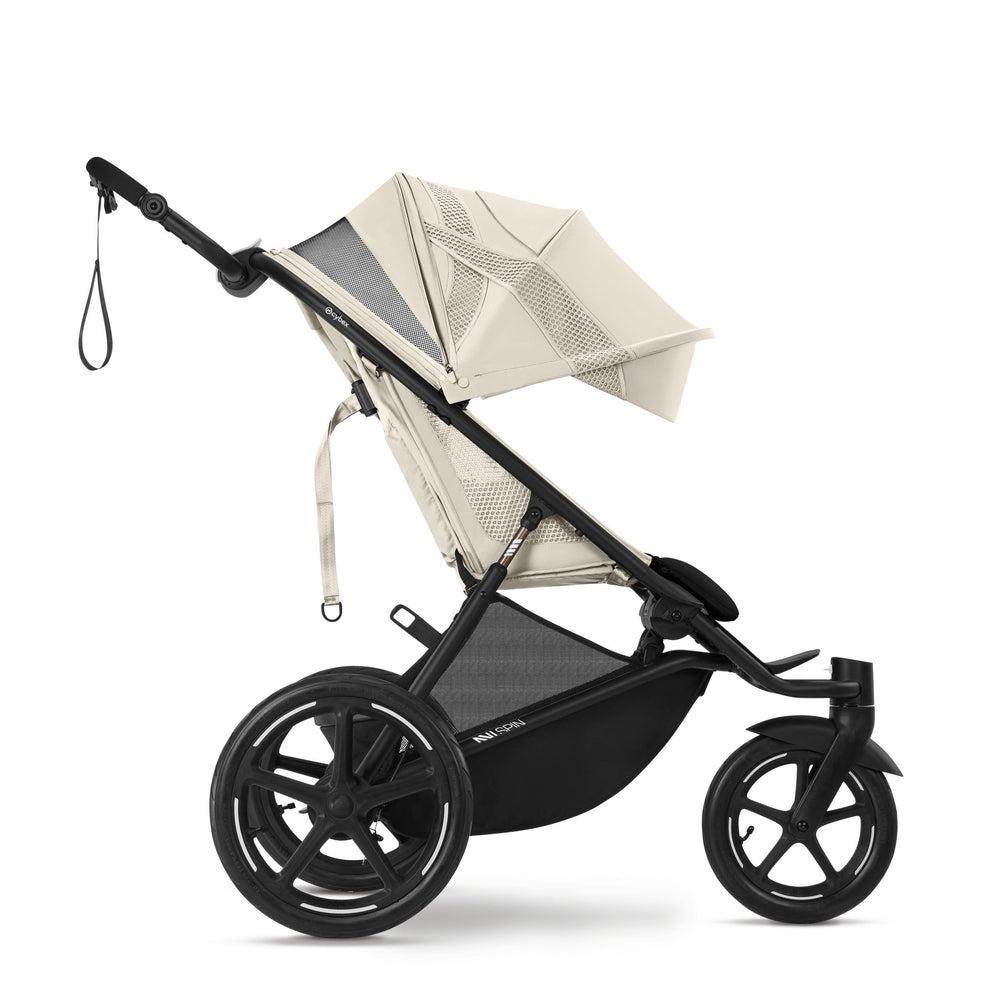 Close-up of the Cybex Avi Spin All Terrain Stroller in beige with black frame, large wheels, and extendable canopy.