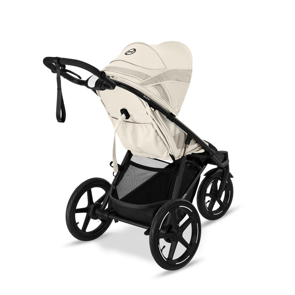 Close-up of the Cybex Avi Spin All Terrain Stroller in beige with a sturdy black frame, large wheels, and adjustable handlebar.