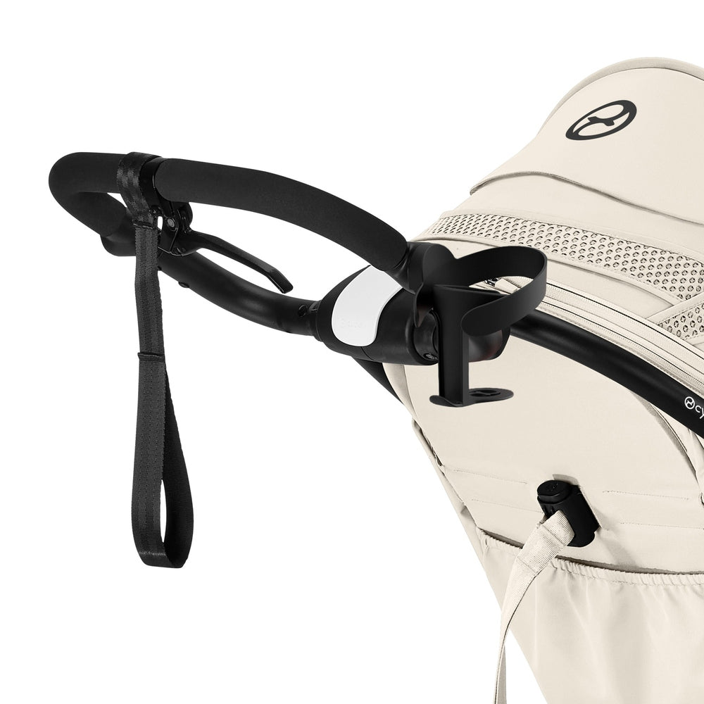 Close-up of the Cybex Avi Spin All Terrain Stroller in beige with black frame, ergonomic handlebar and cup-holder attachment.