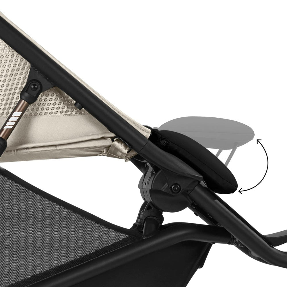 Close-up of the Cybex Avi Spin All Terrain Stroller in beige fabric, showing the adjustable recline hinge for smooth outdoor rides.