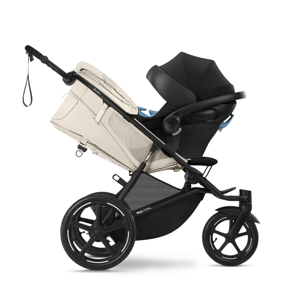 Close-up of the Cybex Avi Spin All Terrain Stroller with beige bassinet attached and black seat, rugged wheels ready for outdoors.