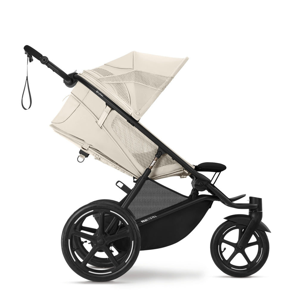 Close-up of the Cybex Avi Spin All Terrain Stroller -beige canopy, black frame, reclining seat with mesh panels and large wheels.