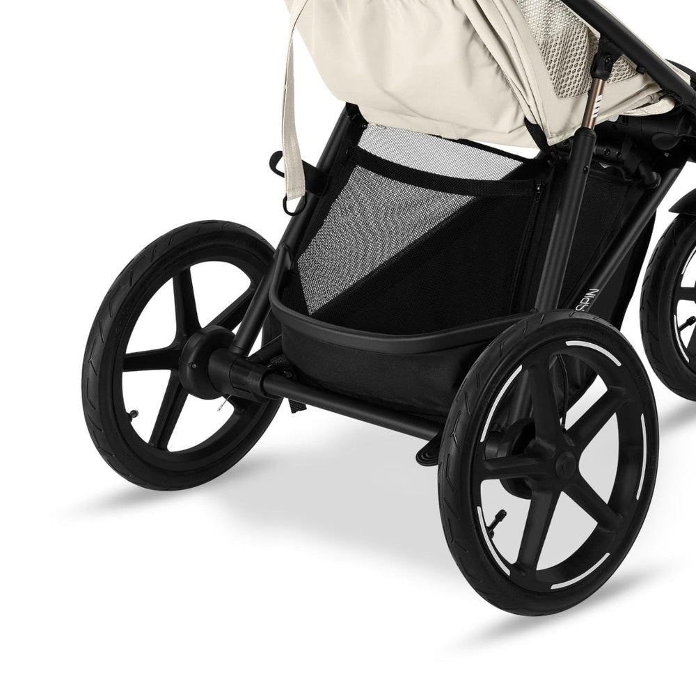 Close-up of the Cybex Avi Spin All Terrain Stroller with large black wheels and mesh storage basket, built for rugged walks.