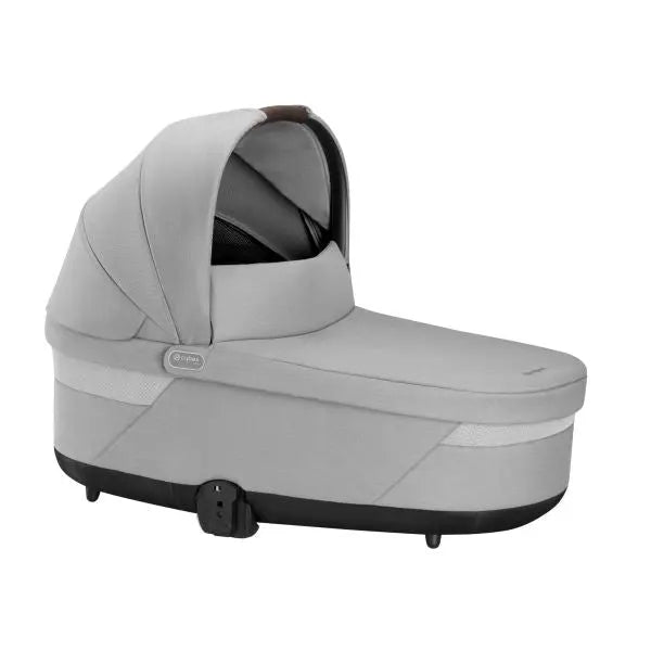 Studio product image of the Cybex Balios S Lux Cot in light grey, side view with canopy extended on a white background.