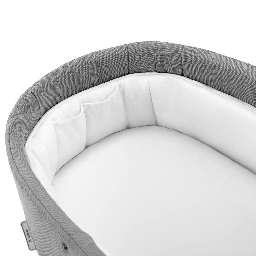 Top view of the Cybex Balios S Lux Cot in light grey, showing the padded interior and mattress.