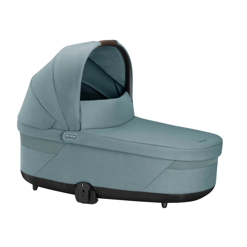 Studio product image of the Cybex Balios S Lux Cot in teal, front three-quarter view on a white background.