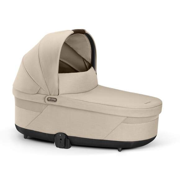 Studio product image of the Cybex Balios S Lux Cot in almond beige, front three-quarter view on a white background.