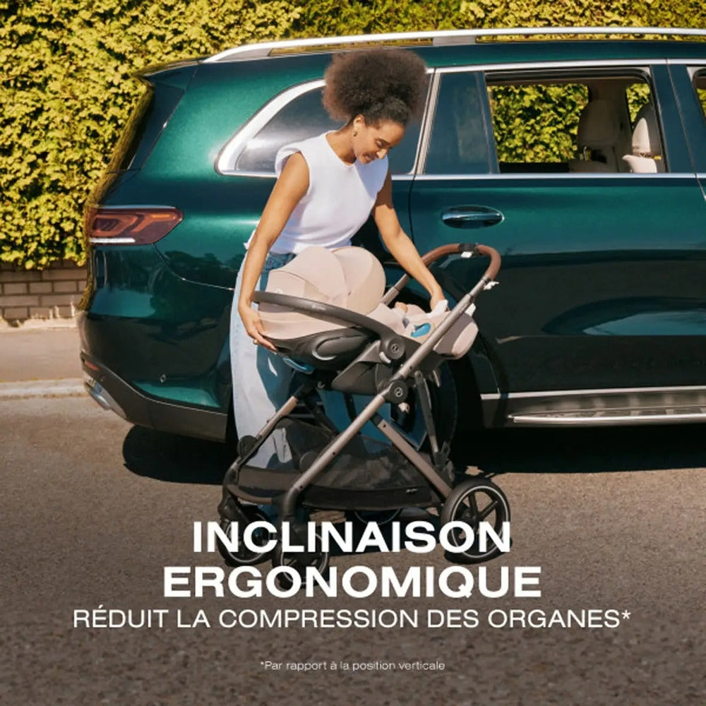 Cybex Cloud G Pro Infant Car Seat with SensorSafe and Load Leg Base in Almond Beige beside an SUV, ergonomic recline lifestyle graphic