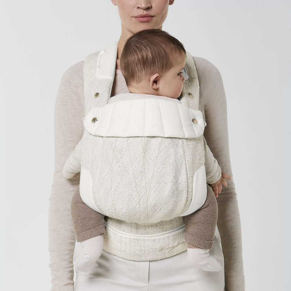 Close-up of the Cybex Coya Carrier Boucle in cream boucle with white padded panels and shoulder straps.